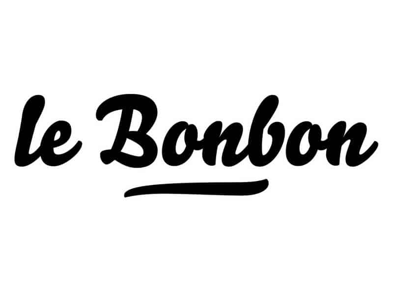 Le Bonbon" est écrit en caractères gras, noirs et cursifs, avec un trait de soulignement incurvé sous le mot.